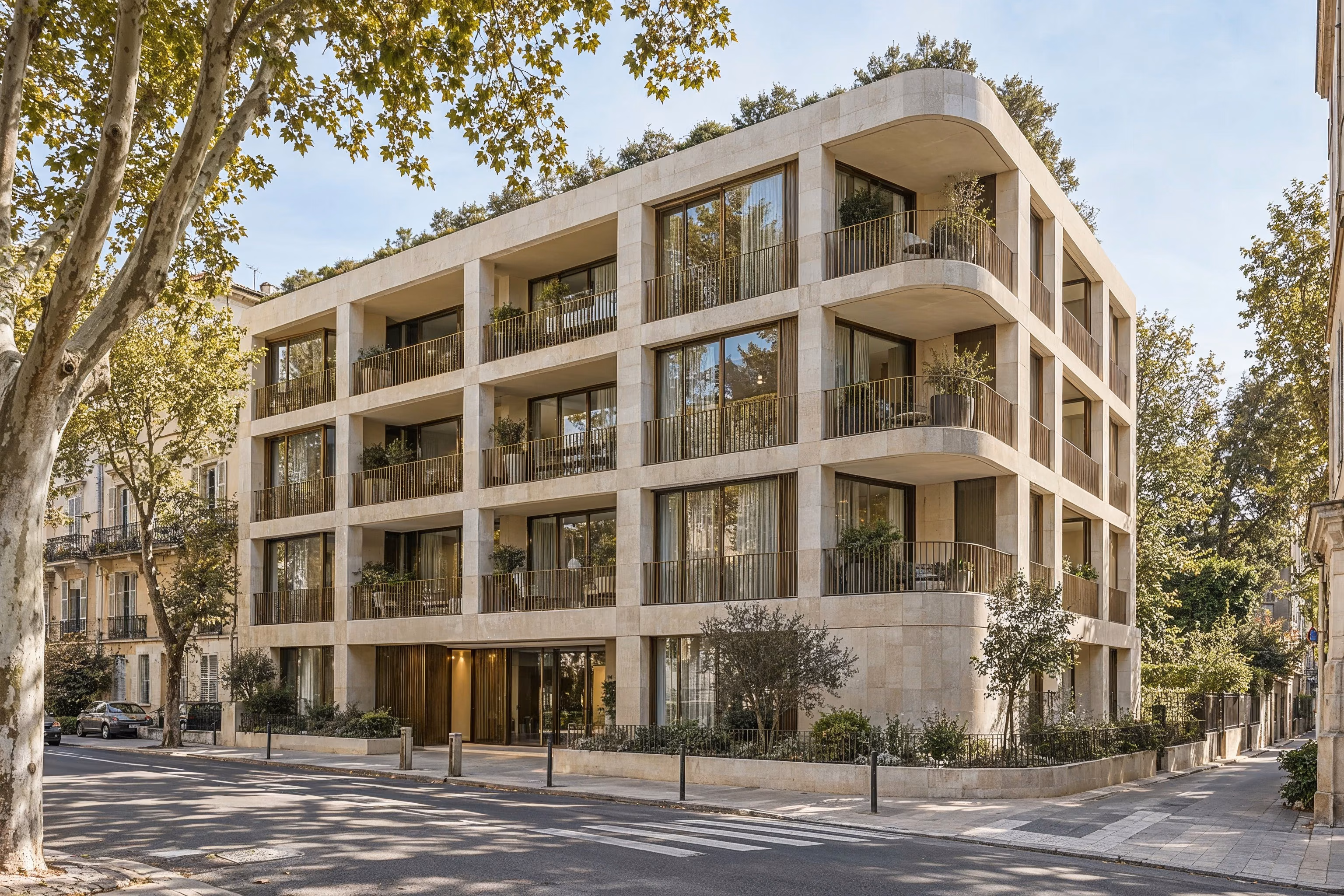 Résidence Sillage — Limestone street-corner facade beneath mature plane trees.